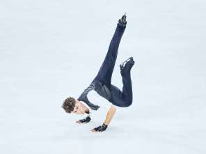 Lukas Britschgi, Eiskunstläufer macht eine Pose auf dem Eis. Er steht auf beiden Händen.